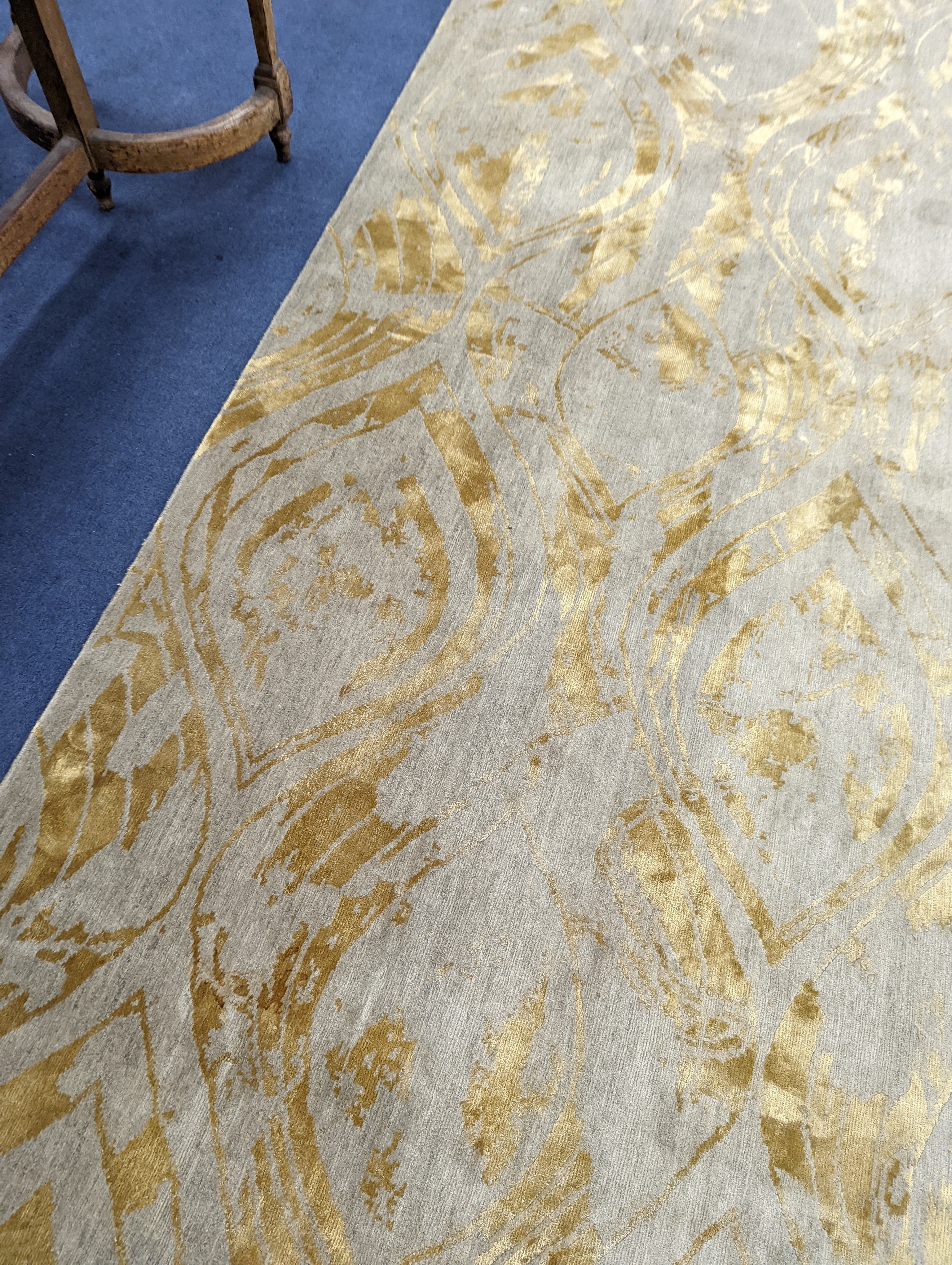 A contemporary 'Son' Nepalese wool and silk stone grey and gold carpet, 490 x 270cm